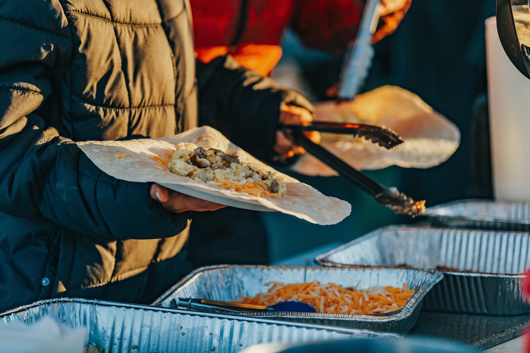 Volunteers have breakfast before beginning construction of a water guzzler for bighorn sheep at the Marine Corps Air Ground Combat Center, Twentynine Palms, Calif., Jan. 4, 2019. Members of the San Bernadino County community joined together with the California Conservation Corps to build a water guzzler in an effort to provide natural resources needed to sustain the bighorn sheep population in the surrounding area. (U.S. Marine Corps photo by Lance Cpl. Aaron Harshaw)