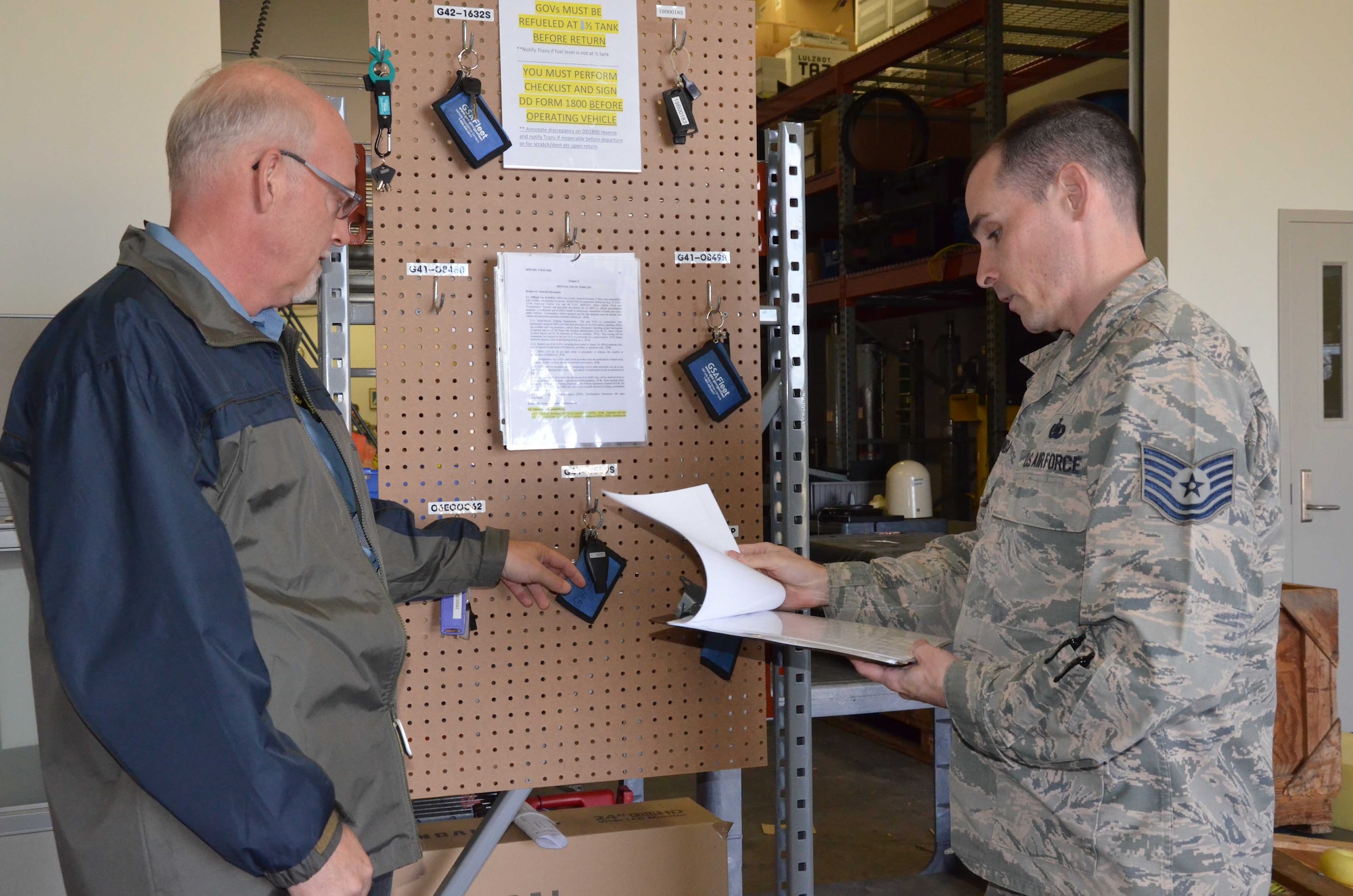 Tech. Sgt. Mark Melchionda (right), 709th Support Squadron section chief of transportation, discusses vehicle dispatch operations with his boss, James Battenfelder, 709th SPTS transportation manager.  The squadron recently streamlined its transportation and shipping operations to more efficiently manage its fleet of vehicles and cargo shipments.