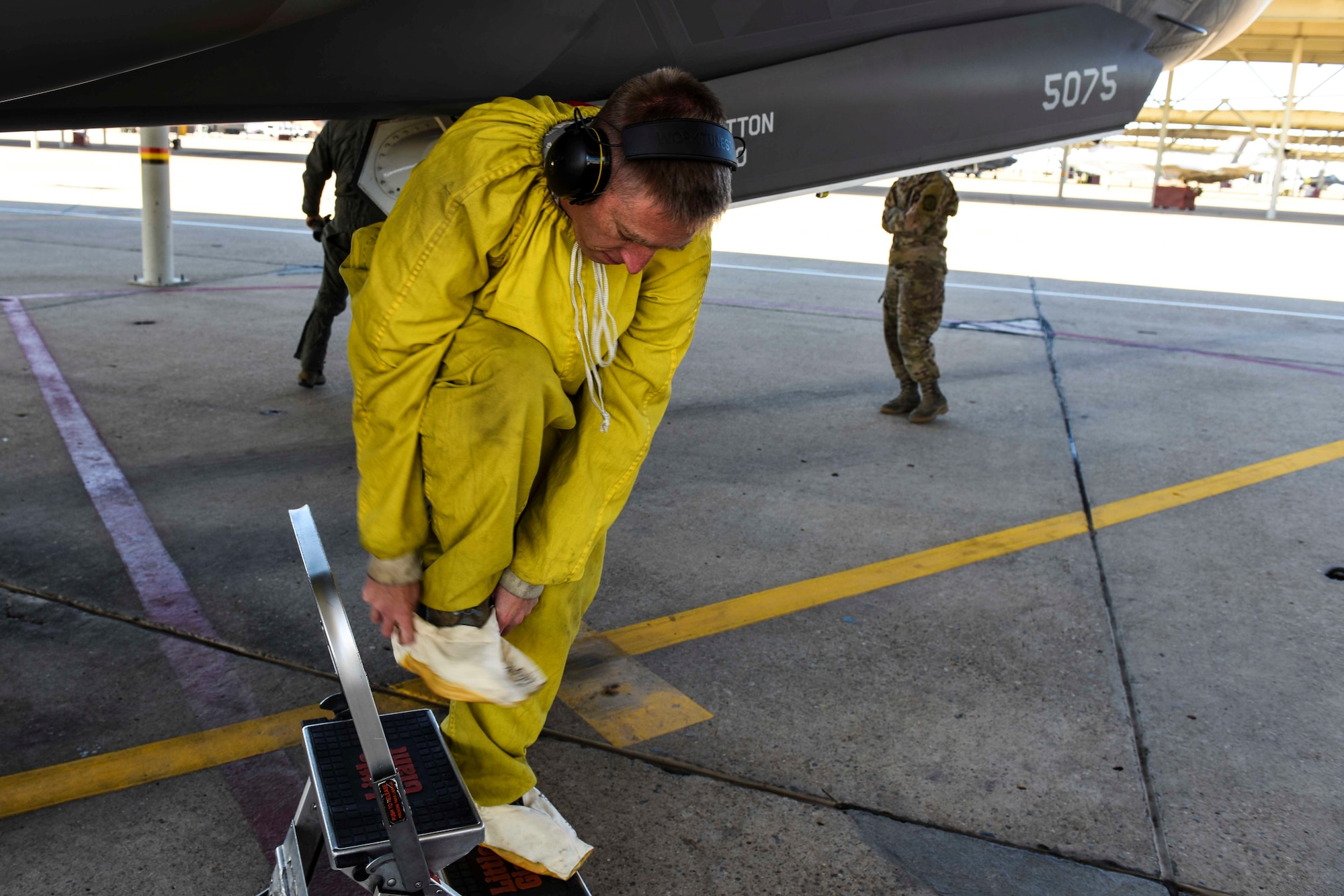 Tech. Sgt. Lance Dooley, a crew chief in the 466th Aircraft Maintenance Unit, prepares to crawl inside the intake of an F-35 Lightning II to perform a post-flight inspection