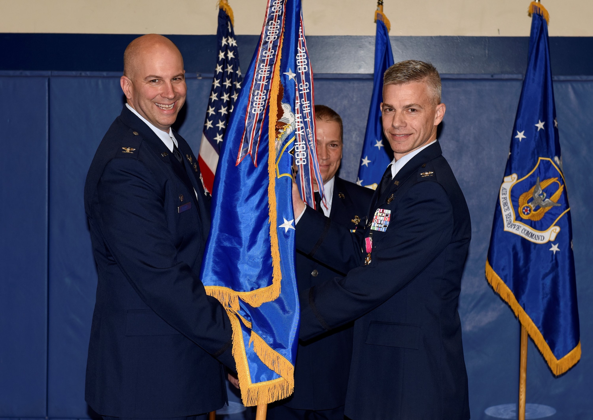 Col. Dean Sniegowski, 310th Space Wing commander, receives the 310th Operations Group guidon from Col. Stephen Slade, outgoing 310th OG commander, during a change of command ceremony Saturday, Jan. 5th, 2019.