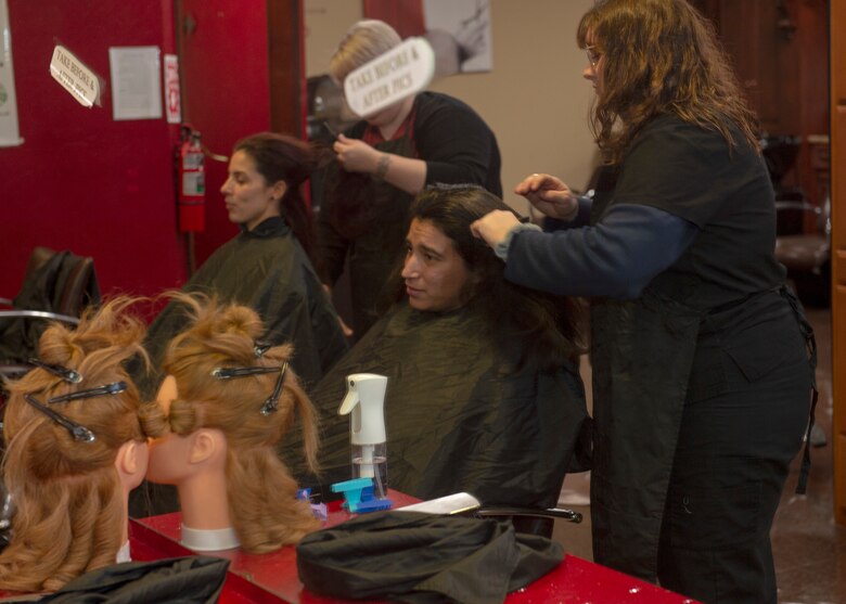 Spouses of members assigned to the 97th Air Mobility Wing receive free haircuts, Jan. 12, 2019, at the Southwest Technology Center, Altus, Okla.