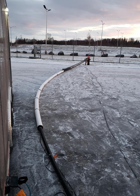 Members of the 773d Civil Engineer Squadron utilities shop assemble a 300-foot section of insulated pipe at Joint Base Elmendorf-Richardson, Alaska, Dec. 1, 2018.  Following the Nov. 30, 2018, earthquake, the Alaska Mission Operations Center suffered a water main break. Due to the long-term cold weather, a temporary solution was decided upon. The innovative thoughts and immediate actions of a handful of Airmen ensured the Alaska Mission Operations Center had water within two days, and saved the U.S. Air Force almost $20,000.