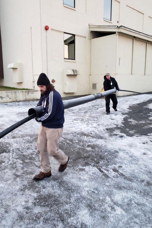 Aaron Bryant and Rick Gill, 773d CES utilities operators, assemble a 300-foot section of insulated pipe at Joint Base Elmendorf-Richardson, Alaska, Dec. 1, 2018.  Following the Nov. 30, 2018, earthquake, the Alaska Mission Operations Center suffered a water main break. Due to the long-term cold weather, a temporary solution was decided upon. The innovative thoughts and immediate actions of a handful of Airmen ensured the Alaska Mission Operations Center had water within two days, and saved the U.S. Air Force almost $20,000.