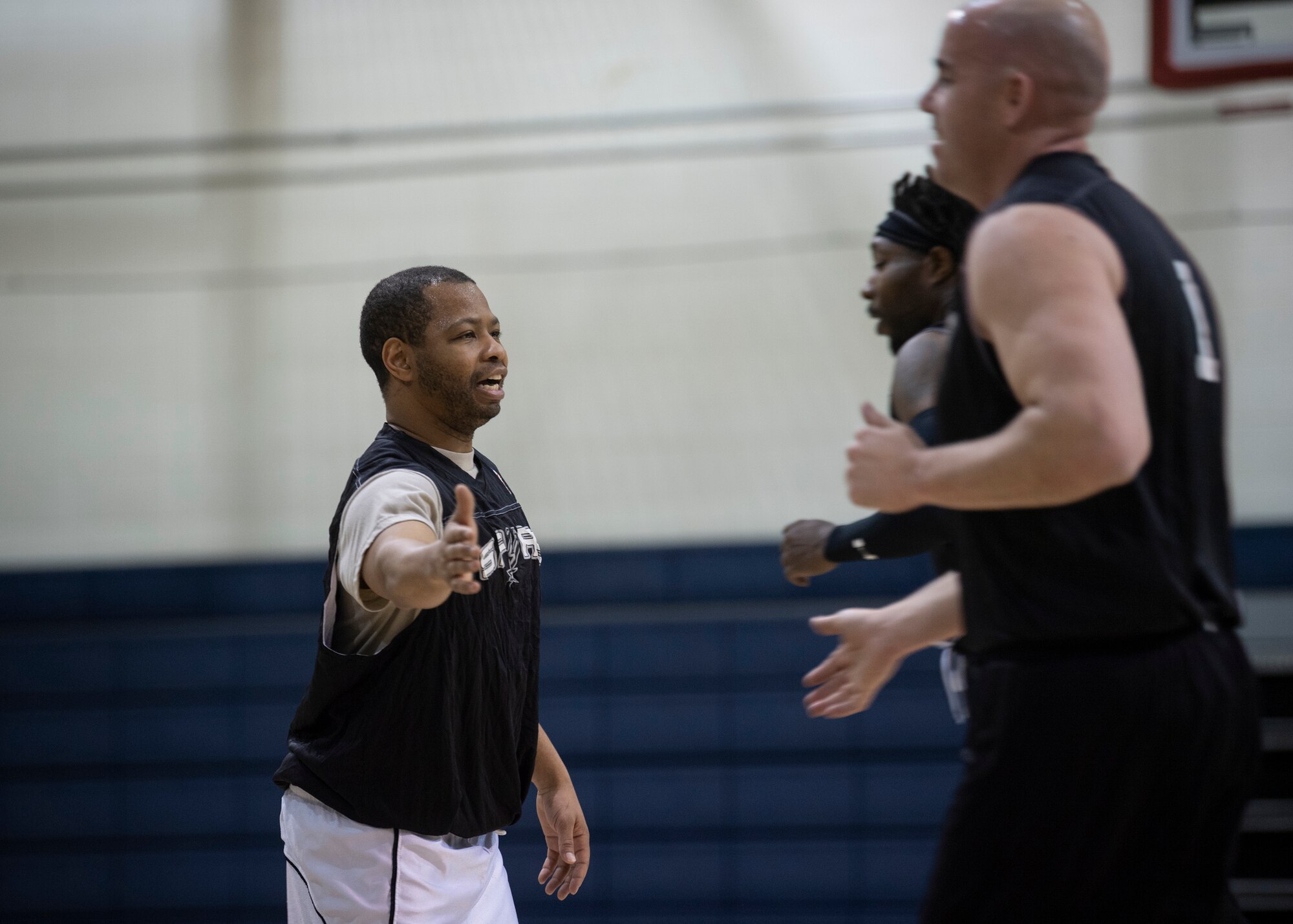 Staff Sgt. Joel Gardner, 377th Force Support Squadron point guard, exchanges high-fives with his teammates, Leon Gibbs, forward and Douglas Eichorn, center during an over 35 intramural basketball game at Kirtland Air Force Base, N.M., Jan. 9, 2019. The over 35 league is the first of its kind offered at Kirtland AFB. (U.S. Air Force photo by Staff Sgt. J.D. Strong II)