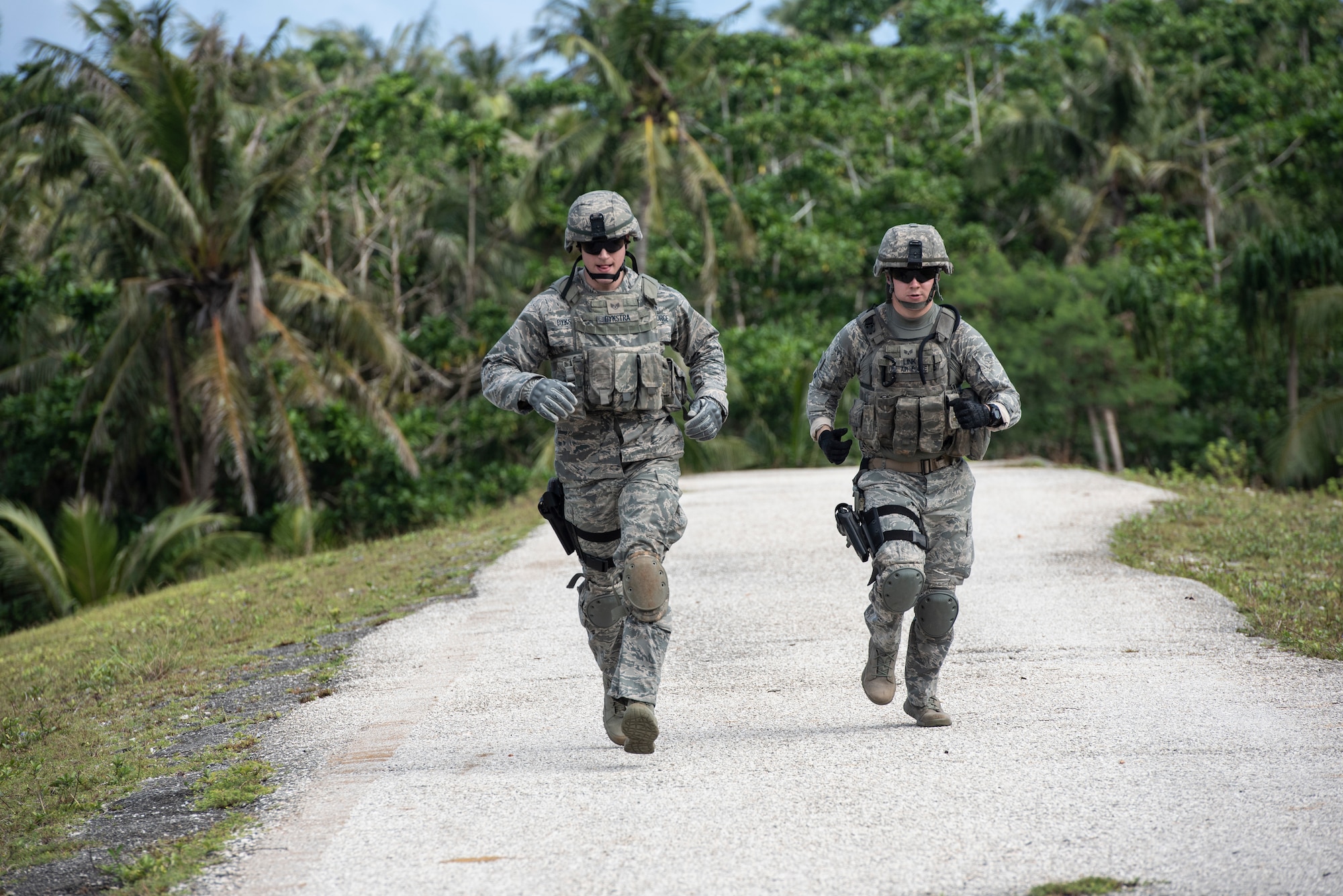 Two students run during the Shoot, Move and Communicate portion of Commando Warrior training at North West Field near Andersen Air Force Base, Guam Dec. 10, 2018. The 736th Security Forces Squadron trains frontline defenders from all bases assigned to Pacific Air Forces on U. S. Central Command and regional training requirements so they can deploy as well as utilize trained skills at their home stations. (U.S. Air Force photo by Master Sgt. JT May III)