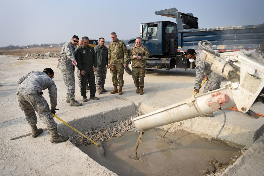 U.S. Air Force Lt. Gen. Kenneth Wilsbach, 7th AF commander, speaks with Master Sgt. Thomas Zemanik, 51st Civil Engineer Squadron pavements and equipment flight (Dirt Boyz) noncommissioned officer in charge during an immersion tour at Osan Air Base, Republic of Korea, Jan. 11, 2019. The Dirt Boyz showcased their technique for repairing damaged areas of a flightline in a process called Rapid Airfield Damage Repair. (U.S. Air Force photo by Senior Airman Kelsey Tucker)