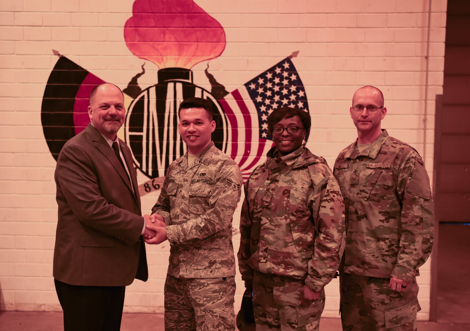 U.S. Air Force Airman 1st Class Joseph R.S. Johnson, 86th Munitions Squadron Stockpile Management crew chief, poses for a photo with Mr. Scott Lockard, 86th Airlift Wing vice director, and enlisted leadership after receiving the Airlifter of the Week award on Jan. 10, 2018, on Ramstein Air Base, Germany. Johnson is responsible for the safe transportation, storage, and handling of a diverse munitions stockpile that supports home station requirements, as well as the entire United States Air Forces in Europe and Africa theater. (U.S. Air Force photo by Airman 1st Class Milton Hamilton)
