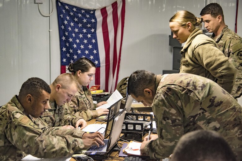 .Airmen of the 332nd Air Expeditionary Wing Financial Management team assist new arrivals during in-processing January 10, 2019.  As the commander’s principal advisor on funding and fiscal issues, FM oversees all the expenditures to enable mission execution and serves as the focal point for assigned members on matters of military and travel pay. (U.S. Air Force photo by Staff Sgt. Stephen G. Eigel)