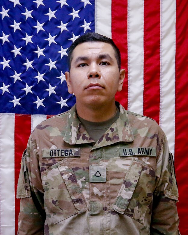 Spc. Andrew Ortega in a unit photo taken prior to deployment.