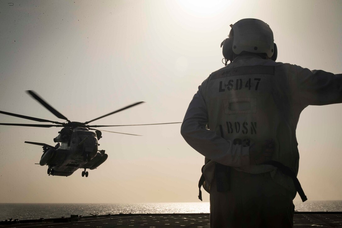 U.S. Navy Chief Warrant Officer 2 Jason Roberts, a boatswain, assigned to the Essex Amphibious Ready Group, watches as a U.S. Marine CH-53E Super Stallion with Marine Medium Tiltrotor Squadron 166 Reinforced, 13th Marine Expeditionary Unit, approaches the Whidbey Island-class dock landing ship USS Rushmore, Jan. 5, 2019. The Essex ARG and the 13th MEU are deployed to the U.S. 5th fleet area of operations in support of naval operations to ensure maritime stability and security in the Central Region, connecting the Mediterranean and the Pacific through the western Indian Ocean and three strategic choke points.