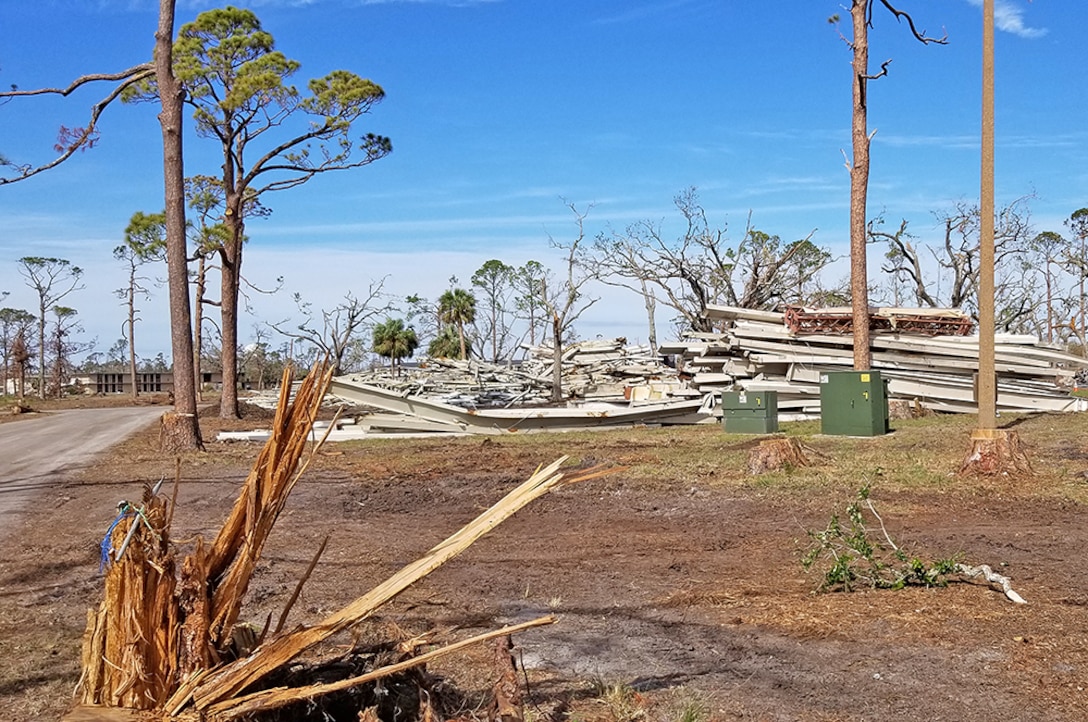 Steel beams await disposal at a Tyndall Air Force Base scrap staging area.