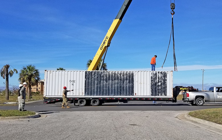Air Force personnel take receipt of a 40-foot shipping container Jan. 8. DLA Disposition Services has provided more than 100 excess container units worth more than $1.1 million for storage of the contents of damaged buildings awaiting demolition.