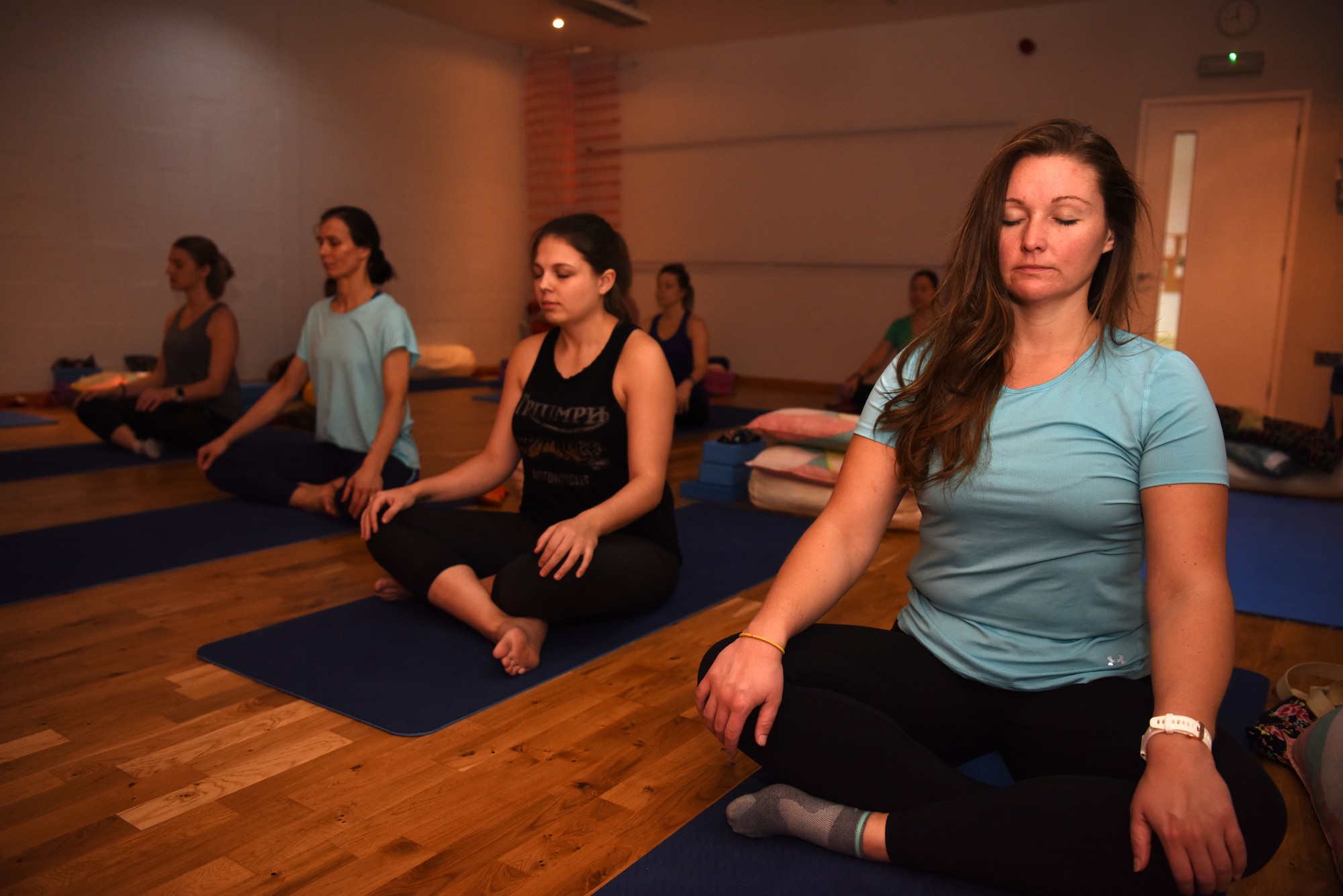 Team Mildenhall spouses take part in a Yin yoga session at a local yoga studio in Newmarket, England, Jan. 10, 2019. The yoga session was part of a Resiliency and Mindfulness Event hosted by Jack Sweet, RAF Mildenhall Community Support Coordinator, and RAFM Key Spouses organization. (U.S. Air Force photo by Airman 1st Class Brandon Esau)