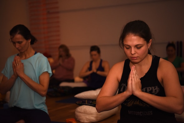 Team Mildenhall spouses practice Yin during a yoga session at a local yoga studio in Newmarket, England, Jan. 10, 2019. The yoga session was part of a Resiliency and Mindfulness Event hosted by Jack Sweet, RAF Mildenhall Community Support Coordinator, and RAFM Key Spouses organization. (U.S. Air Force photo by Airman 1st Class Brandon Esau)