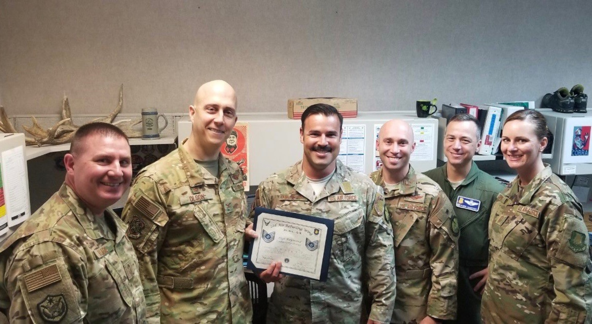 Staff Sgt. Raymond CaballeroPerez, 22nd Operations Support Squadron Survival, Evasion, Recovery and Escape operations and training NCO in charge, poses for a photo with wing leadership Dec. 19, 2018, at McConnell Air Force Base, Kansas. Perez was selected as an Air Mobility Command Stripes to Exceptional Performers promotee for his work as a SERE specialist. (Courtesy photo)