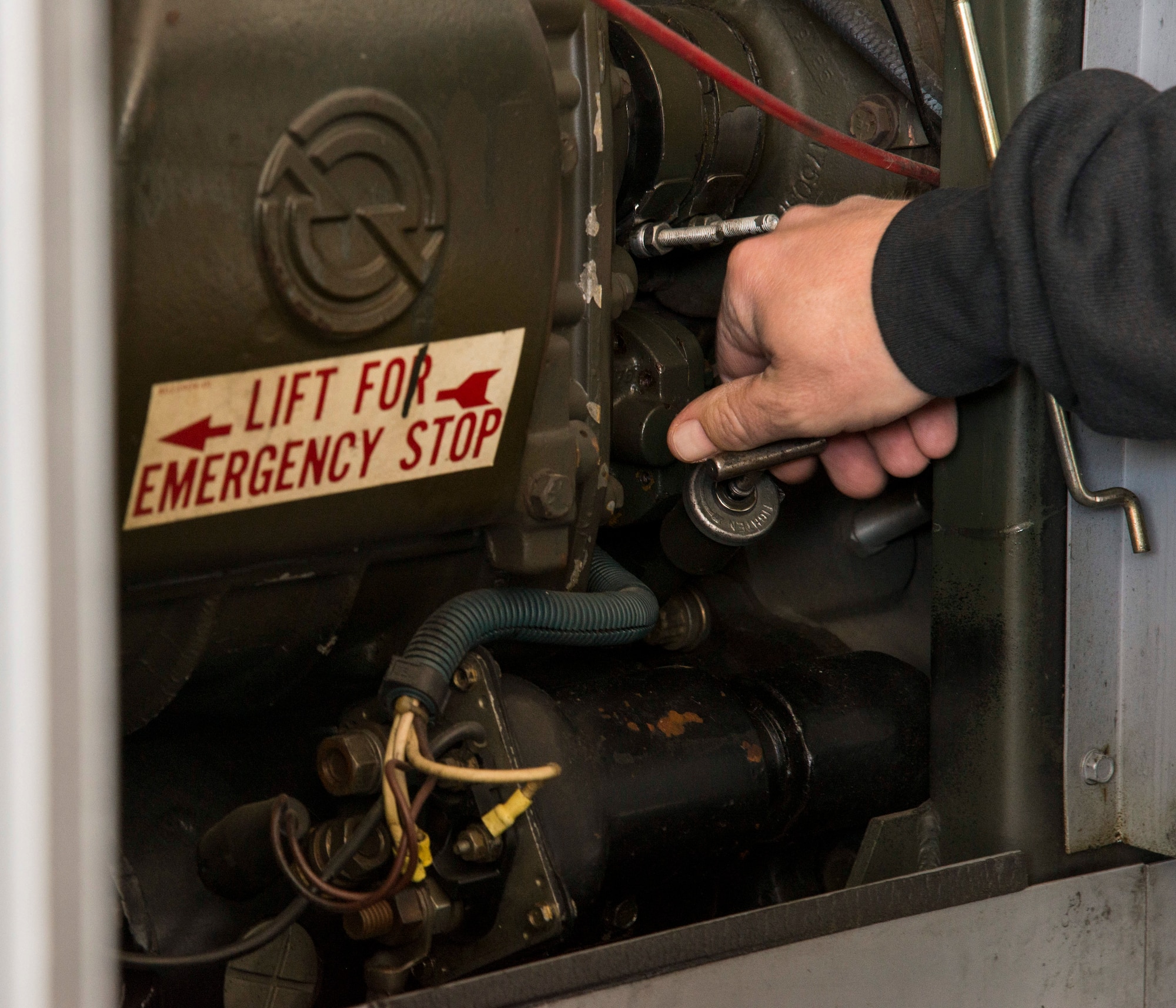 Jeff Dalton, 375th Operation Support Squadron aerospace ground mechanic, checks the oil level on a generator at Scott Air Force Base, Illinois Dec. 12, 2018. Aerospace Ground Equipment performs weekly checks to make sure their equipment is ready for use at any time and can service any transient aircraft stopping at Scott AFB.