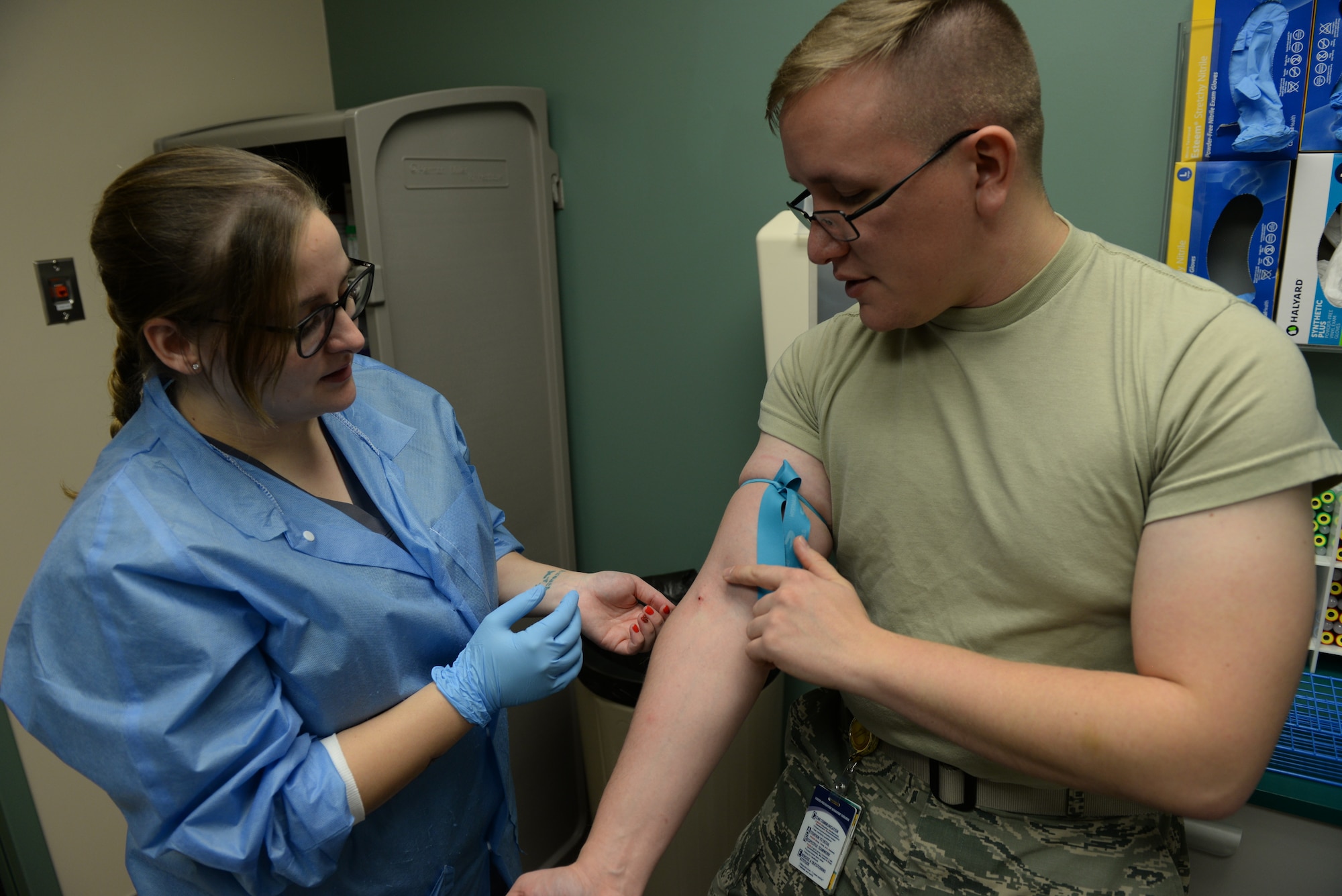 Staff Sgt. Johnathon Barton, the 28th Medical Support Squadron noncommissioned officer in charge of central operations, explains how to properly insert a needle to take blood during a training exercise at the 28th Medical Group laboratory at Ellsworth Air Force Base, S.D., Dec. 4, 2018. Phlebotomists-in-training can intern at the base clinic to get hands on experience for their degree. (U.S. Air Force photo by Airman 1st Class Nicolas Z. Erwin)