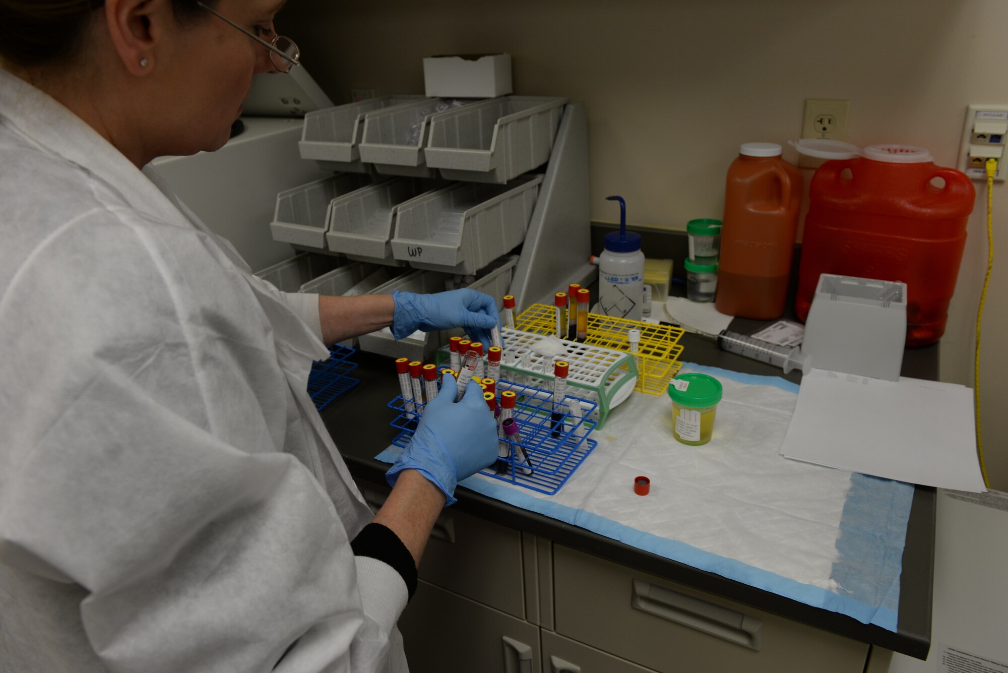 Patti James, a 28th Medical Support Squadron medical laboratory technologist, sorts vials of blood and plasma for shipping at the 28th Medical Group laboratory on Ellsworth Air Force Base, S.D., Dec. 4, 2018. Depending on a person's diet or health, human plasma can range in color and opacity from neon yellow to cloudy red. (U.S. Air Force photo by Airman 1st Class Nicolas Z. Erwin)