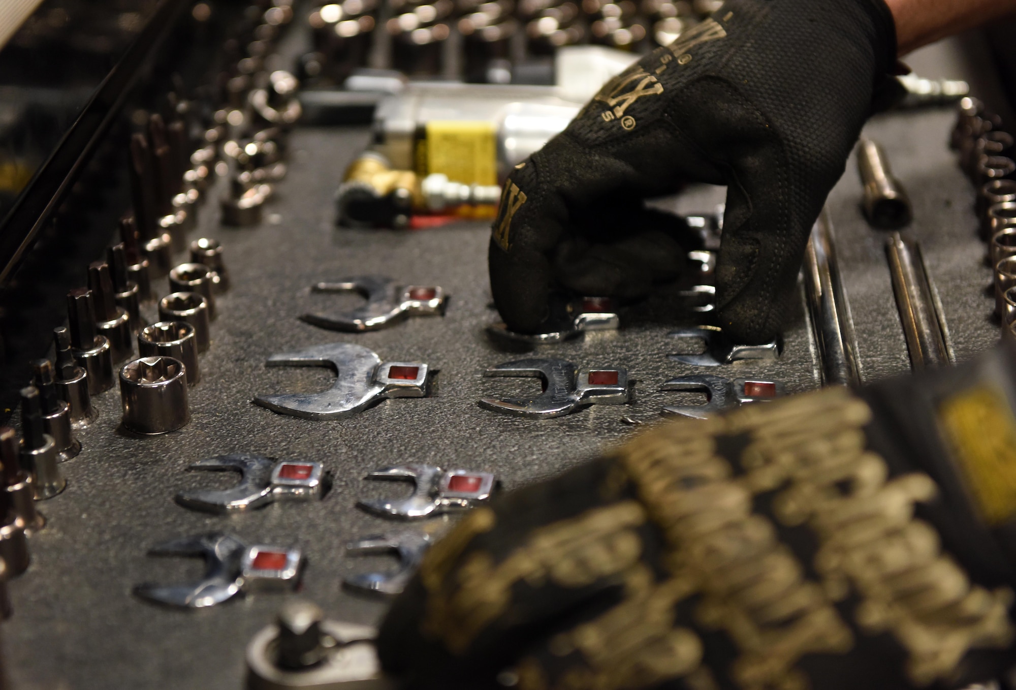 Staff Sgt. Anthony Tavares, a 28th Logistics Readiness Squadron vehicle maintenance equipment supervisor, grabs his tools at Ellsworth Air Force Base, S.D., Dec. 6, 2018. The new vehicles will be fitted with tool cages and racks to assist maintainers and technicians in transporting their larger equipment to and from the destinations, providing better mobility and saving time in the process. (U.S. Air Force photo by Senior Airman Donald C. Knechtel)