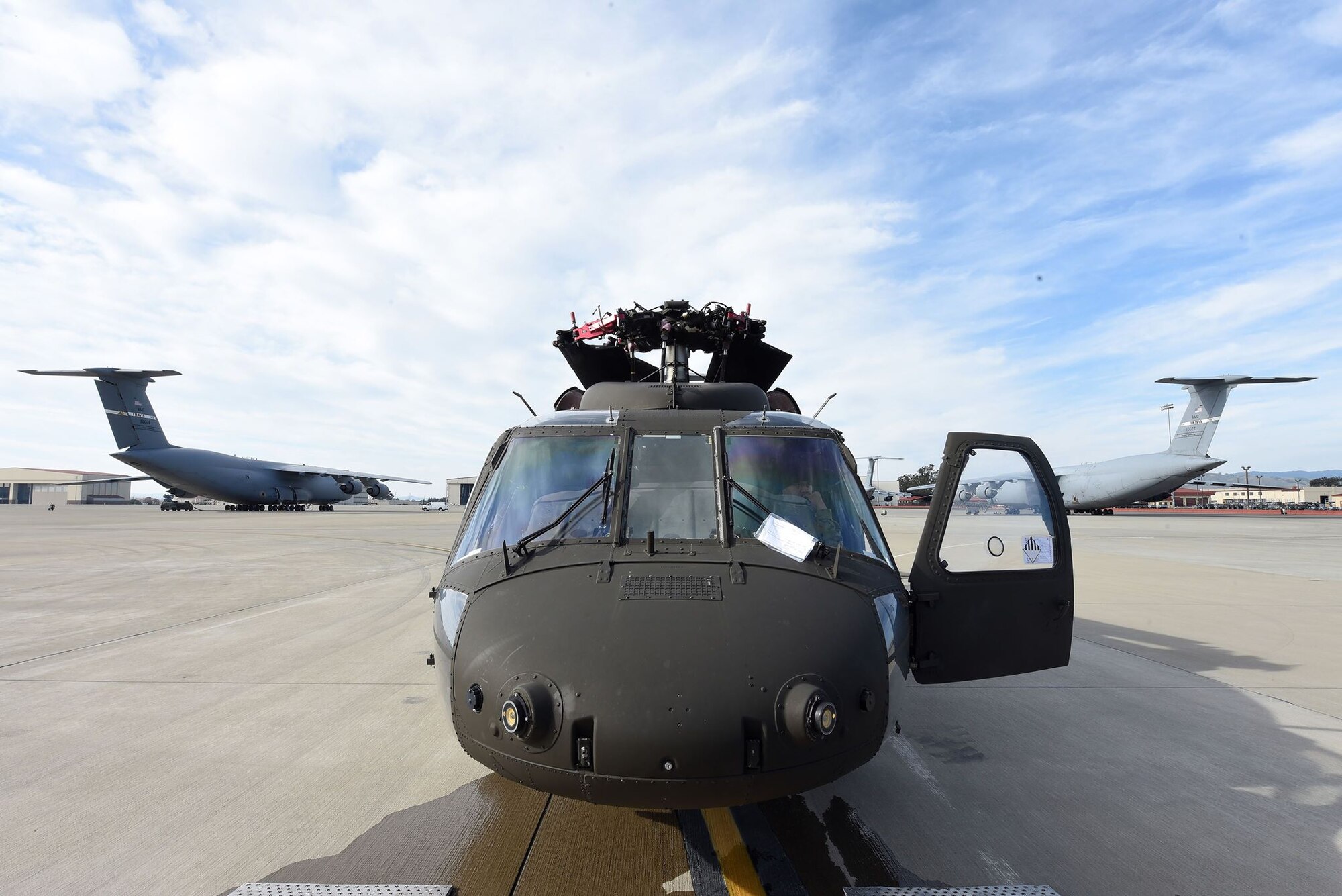 A U.S. Army UH-60 Black Hawk waits to be loaded up into a C-5M Super Galaxy as part of full-spectrum readiness training January 13 at Travis Air Force Base, Calif. The Black Hawks’ normal transport is the C-17 Globemaster III, but the C-5M was offered as transport to the Army in the interest of full-spectrum readiness training for Travis’ C-5M personnel. (U.S. Air Force photo by Airman 1st Class Christian Conrad)
