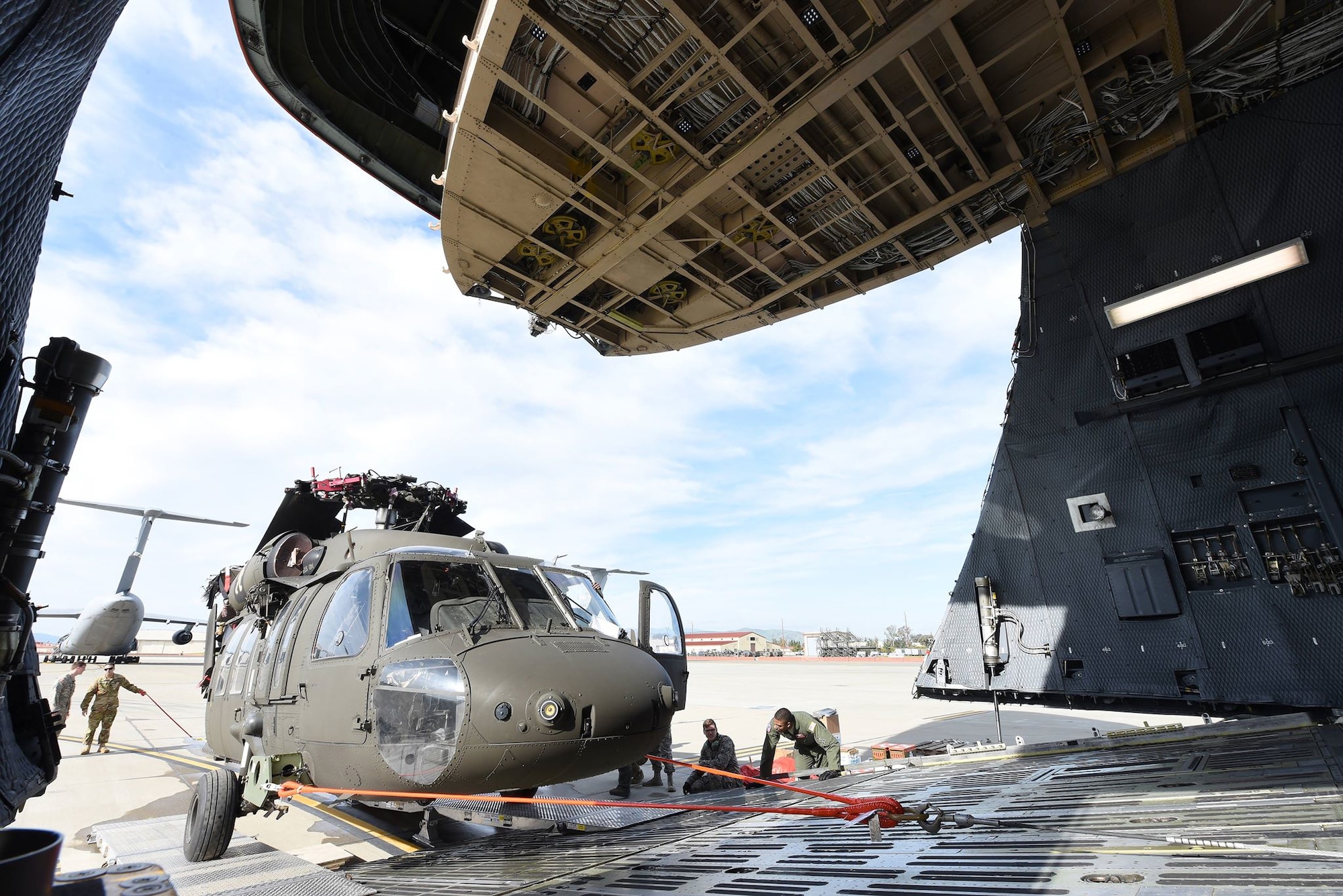A U.S. Army UH-60 Black Hawk is loaded into a C-5M Super Galaxy as part of full-spectrum readiness training January 13 at Travis Air Force Base, Calif. The Black Hawks’ normal transport is the C-17 Globemaster III, but the C-5M was offered as transport to the Army in the interest of full-spectrum readiness training for Travis’ C-5M personnel. (U.S. Air Force photo by Airman 1st Class Christian Conrad)