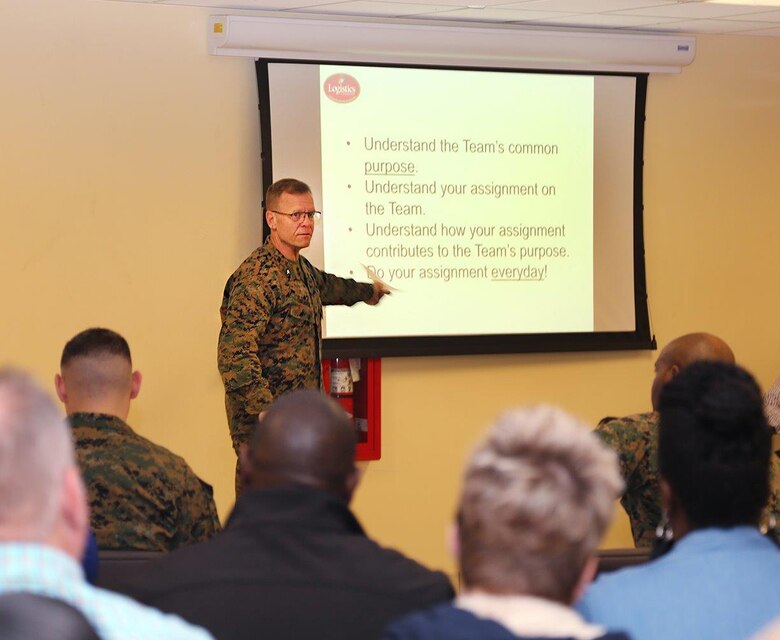 Brig. Gen. Joseph F. Shrader, commanding general, LOGCOM, discusses his fourth line of effort, team concept, with Marines and civilian-Marines during a town hall meeting held in LOGCOM’s Multi-Purpose Room, Jan. 8.