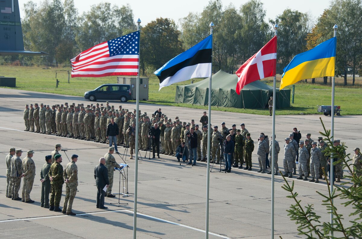 A formation of Americans, Estonians, Swiss and Ukrainian military members stand together at the opening ceremony of exercise Clear Sky in 2018, a multinational flight-centered exercise held at Vinnytsia Air base, Ukraine.