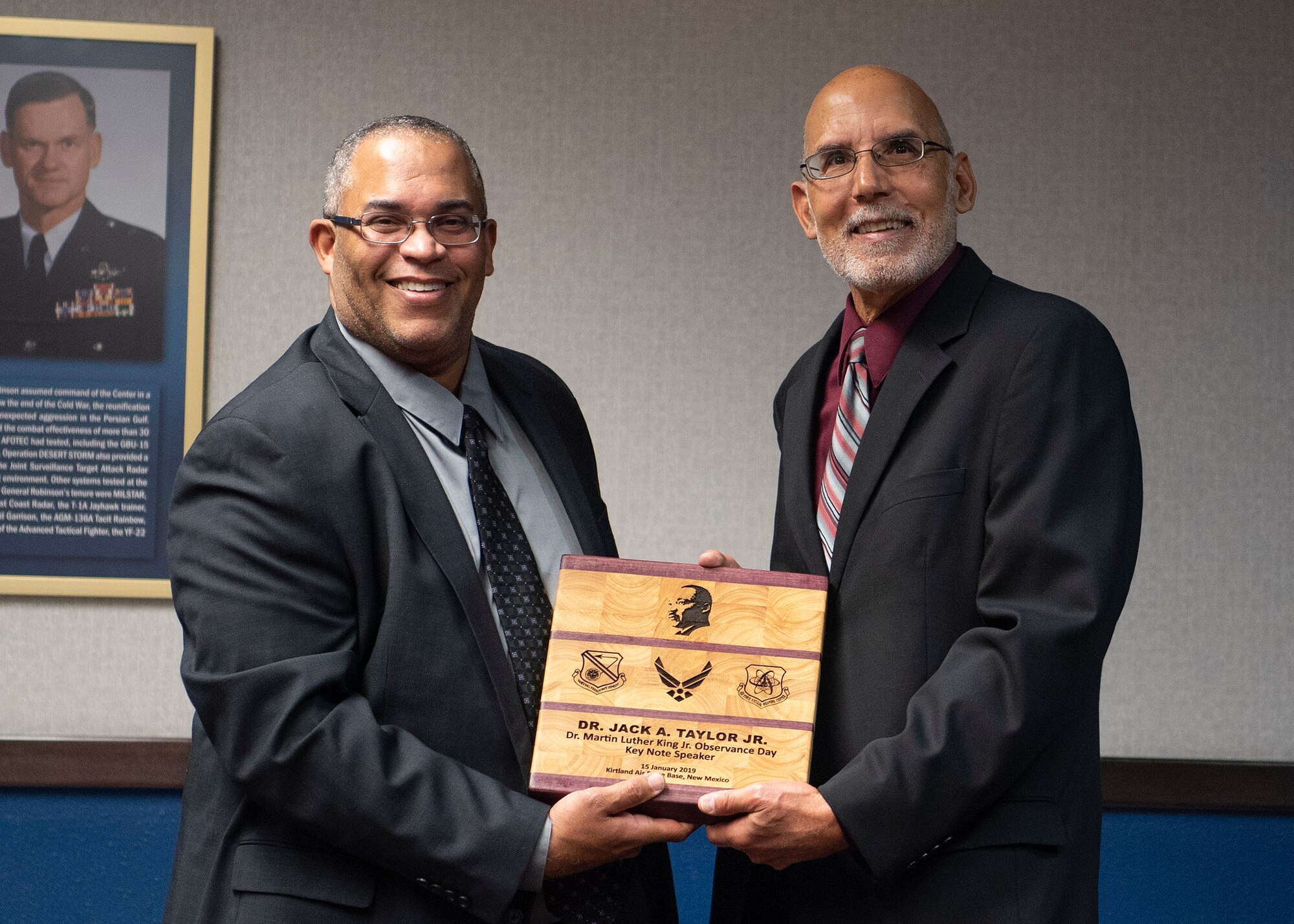 Lt. Col. (Ret.) Jeffrey Fason, Air Force Nuclear Weapon Center program manager, presents Dr. Jack A. Taylor Jr., with a memento for being the guest speaker at the Dr. Martin Luther King Jr. Observance ceremony at Kirtland Air Force Base, N.M., Jan. 15, 2019. Dr. Taylor spoke on the theme of this year’s MLK day, “Where do we go from here: a tradition of resistance.” (U.S. Air Force photo by Staff Sgt. J.D. Strong II)