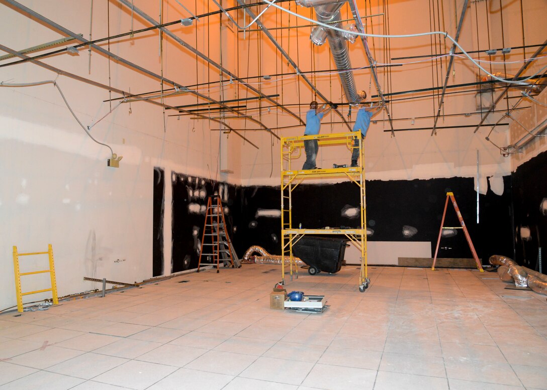 A construction crew works inside building 1020 to prepare the 412th Electronic Warfare Group for the Joint Simulation Environment computer systems and simulators. A 70,000 square foot JSE facility will be built, however engineers are installing a scaled-down version inside building 1020 to allow engineers time to fully integrate and learn about the new system. (U.S. Air Force photo by Giancarlo Casem)