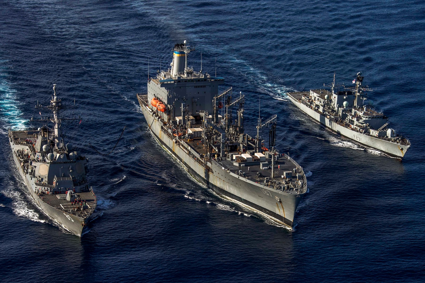 SOUTH CHINA SEA (Jan. 12, 2019) The Arleigh Burke-class guided-missile destroyer USS McCampbell (DDG 85), the Military Sealift Command fleet replenishment oiler USNS Henry J. Kaiser (T-AO 187), and the Royal Navy Type 23 ‘Duke’ Class guided-missile frigate HMS Argyll (F231) transit during a replenishment-at-sea. McCampbell is forward-deployed to the U.S. 7th Fleet area of operations in support of security and stability in the Indo-Pacific region.