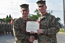 Petty Officer 1st Class Jackson Dehn, a hospital corpsman with 3rd Medical Battalion, 3rd Marine Logistics Group, receives a Navy and Marine Corps Achievement Medal from Brig. Gen. Keith D. Reventlow, commanding general of 3rd MLG, Jan 15, 2019 at Camp Foster, Okinawa, Japan. Dehn was recognized by Reventlow after winning Senior Sailor of the Year for 3rd MLG. Each year, enlisted sailors across III Marine Expeditionary Force compete at the battalion, regimental and major subordinate command levels for Blue Jacket, Sailor and Senior Sailor of the Year. (U.S. Marine Corps photo by Sgt. Tiffany Edwards)