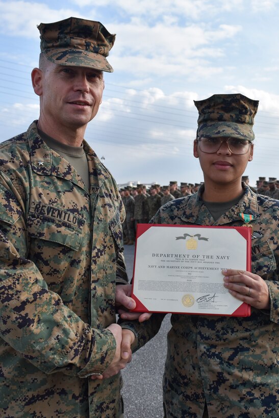 Petty Officer 2nd Class Deika Valerio, a hospital corpsman with 3rd Medical Battalion, 3rd Marine Logistics Group, receives a Navy and Marine Corps Achievement Medal from Brig. Gen. Keith D. Reventlow, commanding general of 3rd MLG, Jan 15, 2019 at Camp Foster, Okinawa, Japan. Valerio was recognized by Reventlow after winning Sailor of the Year for 3rd MLG. Each year, enlisted sailors across III Marine Expeditionary Force compete at the battalion, regimental and major subordinate command levels for Blue Jacket, Sailor and Senior Sailor of the Year. (U.S. Marine Corps photo by Sgt. Tiffany Edwards)