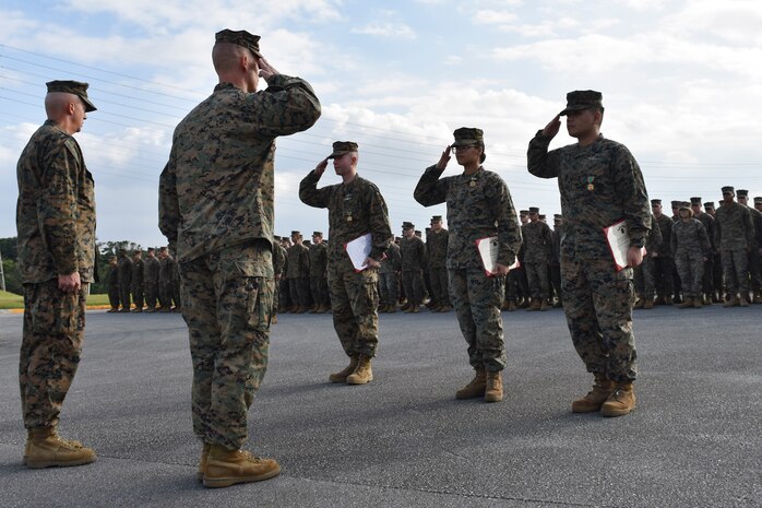 Petty Officer 1st Class Jackson Dehn (center), Petty Officer 2nd Class Deika Valerio and Seaman Rock Ignacio (far right) salute Brig. Gen. Keith D. Reventlow, the commanding general of 3rd Marine Logistics Group, during an awards ceremony Jan. 15 at Camp Foster, Okinawa, Japan. The three hospital corpsmen with 3rd Medical Battalion, 3rd Marine Logistics Group, received a Navy and Marine Corps Achievement Medal from Reventlow, after winning Senior Sailor of the Year for 3rd MLG. Each year, enlisted sailors across III Marine Expeditionary Force compete at the battalion, regimental and major subordinate command levels for Senior Sailor, Sailor and Blue Jacket of the Year, respectively. (U.S. Marine Corps photo by Sgt. Tiffany Edwards)