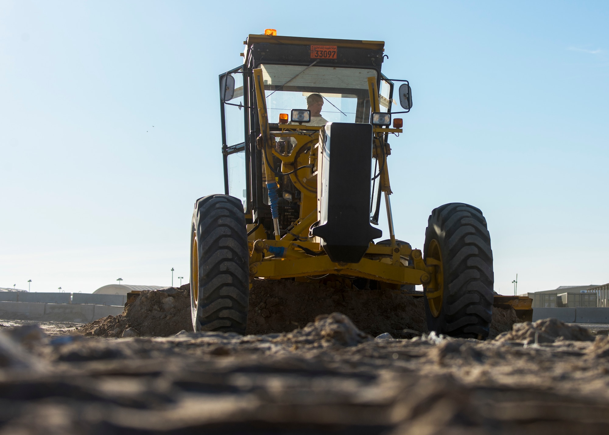 Staff Sgt. Patrick Chuba, 386th Expeditionary Civil Engineer Squadron pavement and equipment journeyman, spreads the newly added fill dirt during the construction of a new road at an undisclosed location in Southwest Asia, Jan 10, 2018. The road will help minimize the amount of traffic through the heart of base after it is completed.