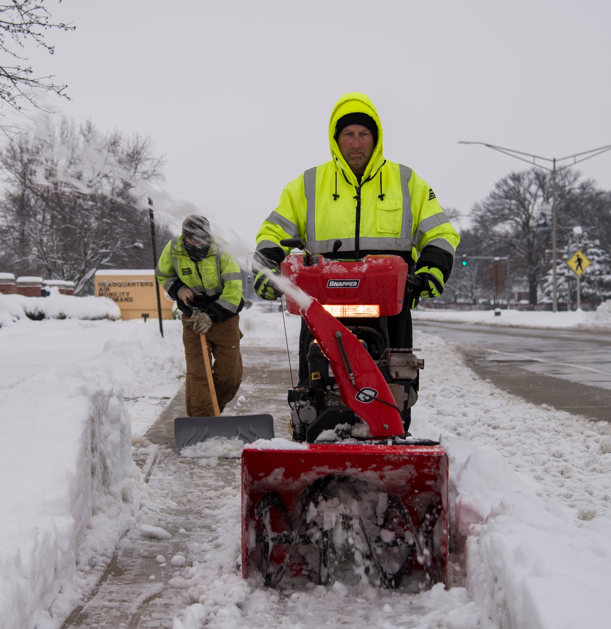 Members of the Ability One Program ground maintenance, clear the sidewalk in front of Air Mobility Command Headquarters, Jan. 12, 2019, at Scott Air Force Base, Ill. Members of the Ability One Program assisted with snow and ice removal alongside members of the 375th Civil Engineer Squadron.
