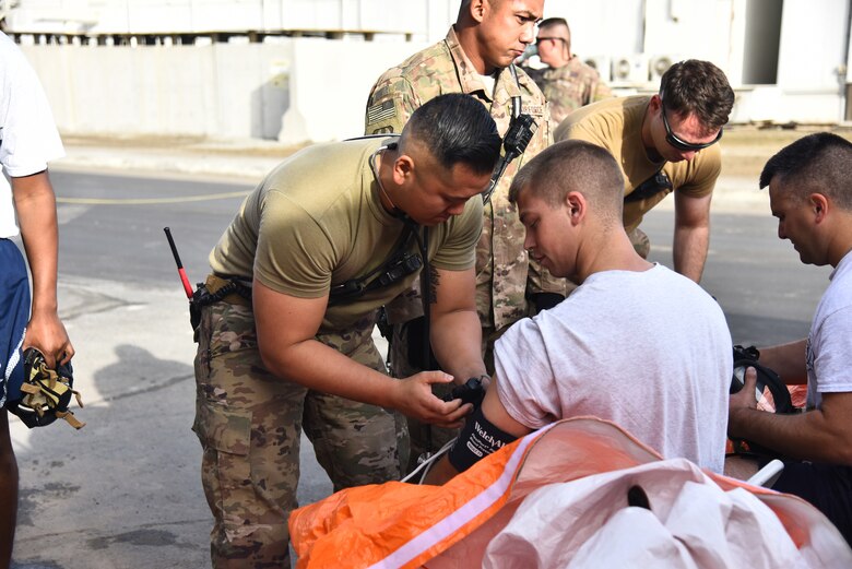624th Civil Engineer Squadron Reservists Senior Airman Peter Yoon, 380th Expeditionary Civil Engineer Squadron emergency manager, checks vital signs during the hazardous material exercise Jan. 4, 2019 at Al Dhafra Air Base, United Arab Emirates.