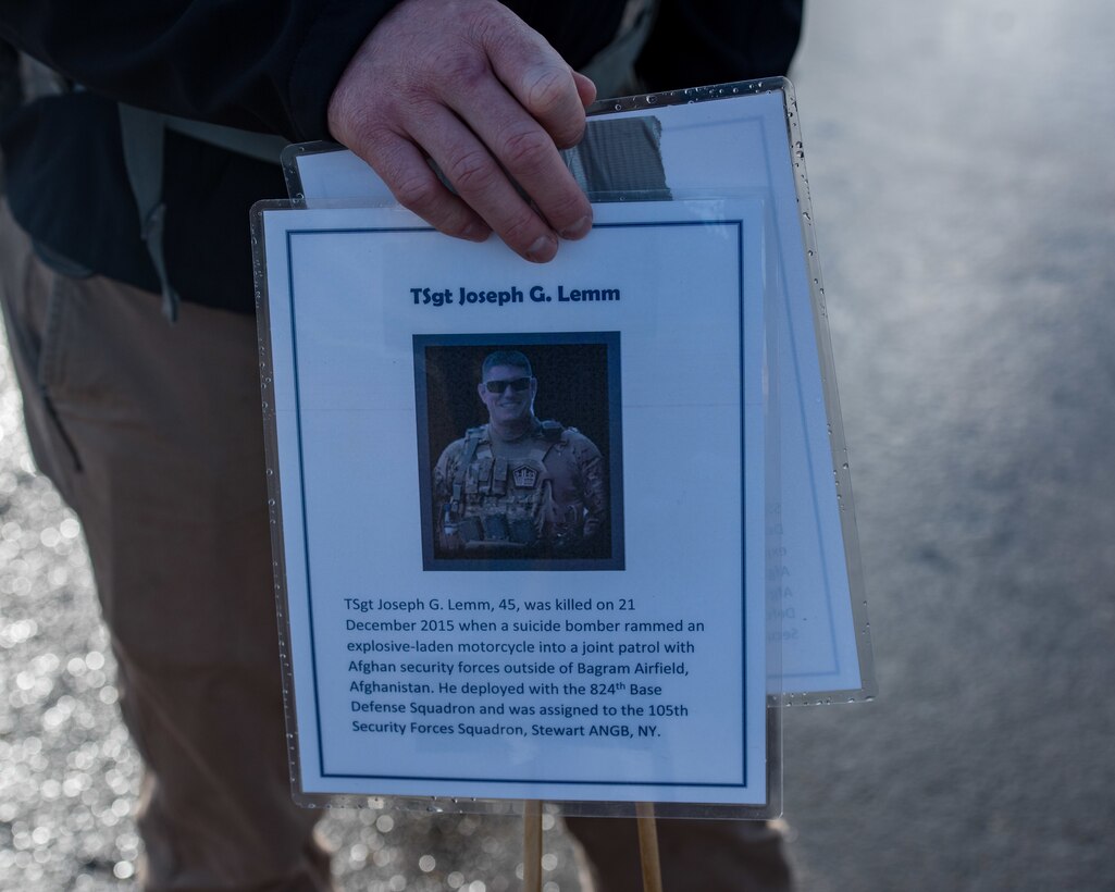 A marker is placed to commemorate U.S. Air Force Tech. Sgt. Joseph Lemm, 45, with the 105th Security Forces Squadron at Stewart Air National Guard Base, New York, during a ruck march in memory of joint patrol team Hustler 6 at Joint Base Langley-Eustis, Virginia, Dec. 21, 2018.