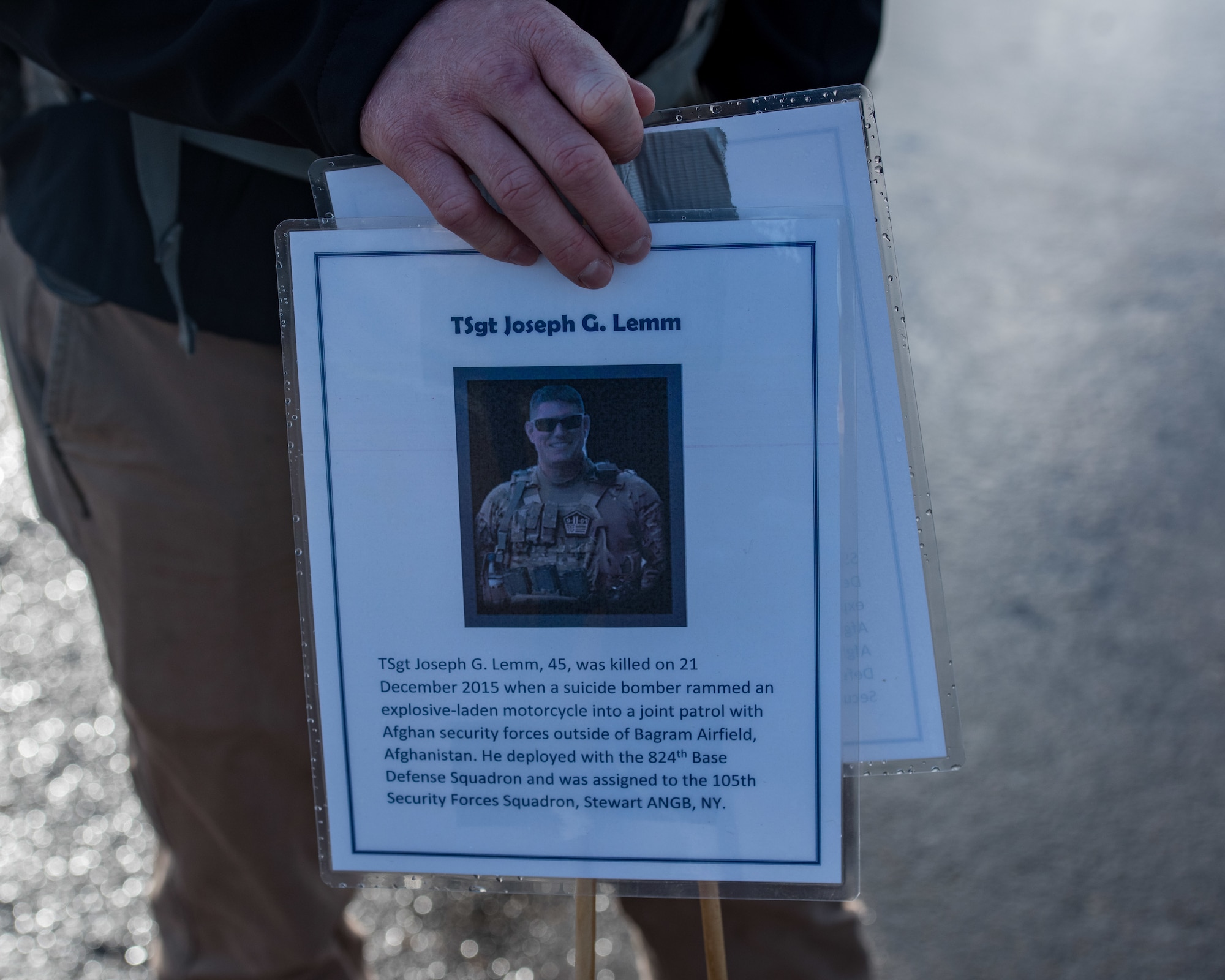 A marker is placed to commemorate U.S. Air Force Tech. Sgt. Joseph Lemm, 45, with the 105th Security Forces Squadron at Stewart Air National Guard Base, New York, during a ruck march in memory of joint patrol team Hustler 6 at Joint Base Langley-Eustis, Virginia, Dec. 21, 2018.