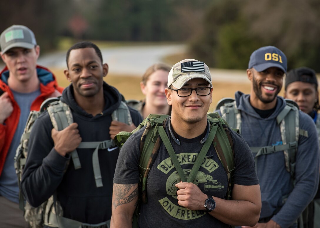 Members of the 633rd Security Forces Squadron, Air Force Office of Special Investigation and Naval Criminal Investigative Services listen to stories about joint patrol team Hustler 6 members at Joint Base Langley-Eustis, Virginia, Dec. 21, 2018.