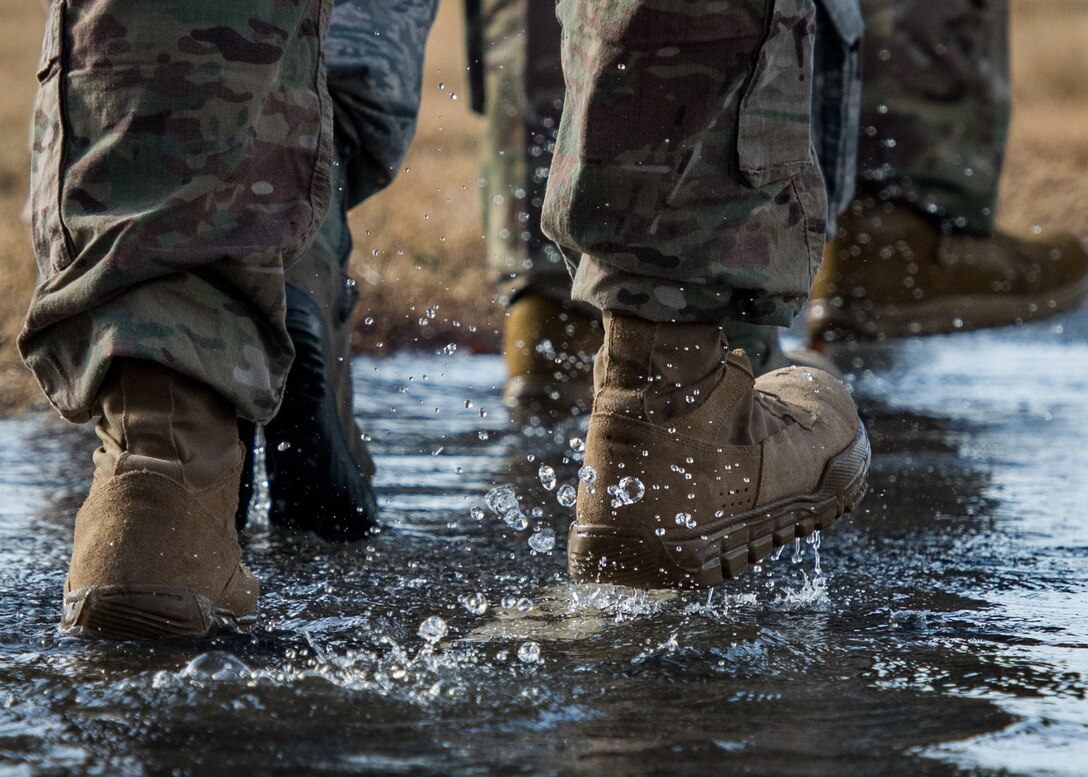 Members of the 633rd Security Forces Squadron, Air Force Office of Special Investigation and Naval Criminal Investigative Services conduct a ruck march in memory of joint patrol team Hustler 6 at Joint Base Langley-Eustis, Virginia, Dec. 21, 2018.