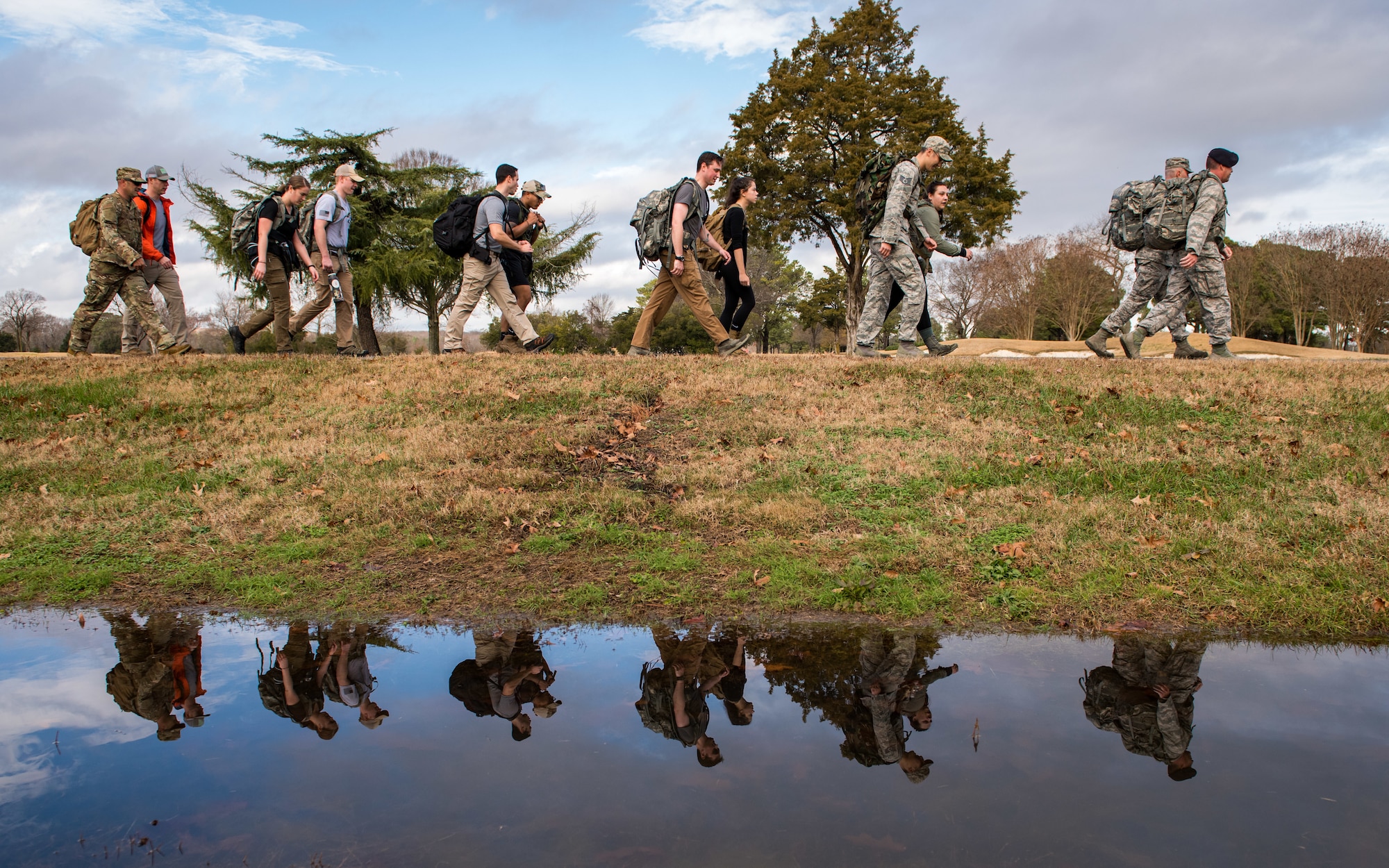 Members of the 633rd Security Forces Squadron, Air Force Office of Special Investigation and Naval Criminal Investigative Services conduct a ruck march in memory of joint patrol team Hustler 6 at Joint Base Langley-Eustis, Virginia, Dec. 21, 2018.