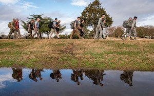 Members of the 633rd Security Forces Squadron, Air Force Office of Special Investigation and Naval Criminal Investigative Services conduct a ruck march in memory of joint patrol team Hustler 6 at Joint Base Langley-Eustis, Virginia, Dec. 21, 2018.