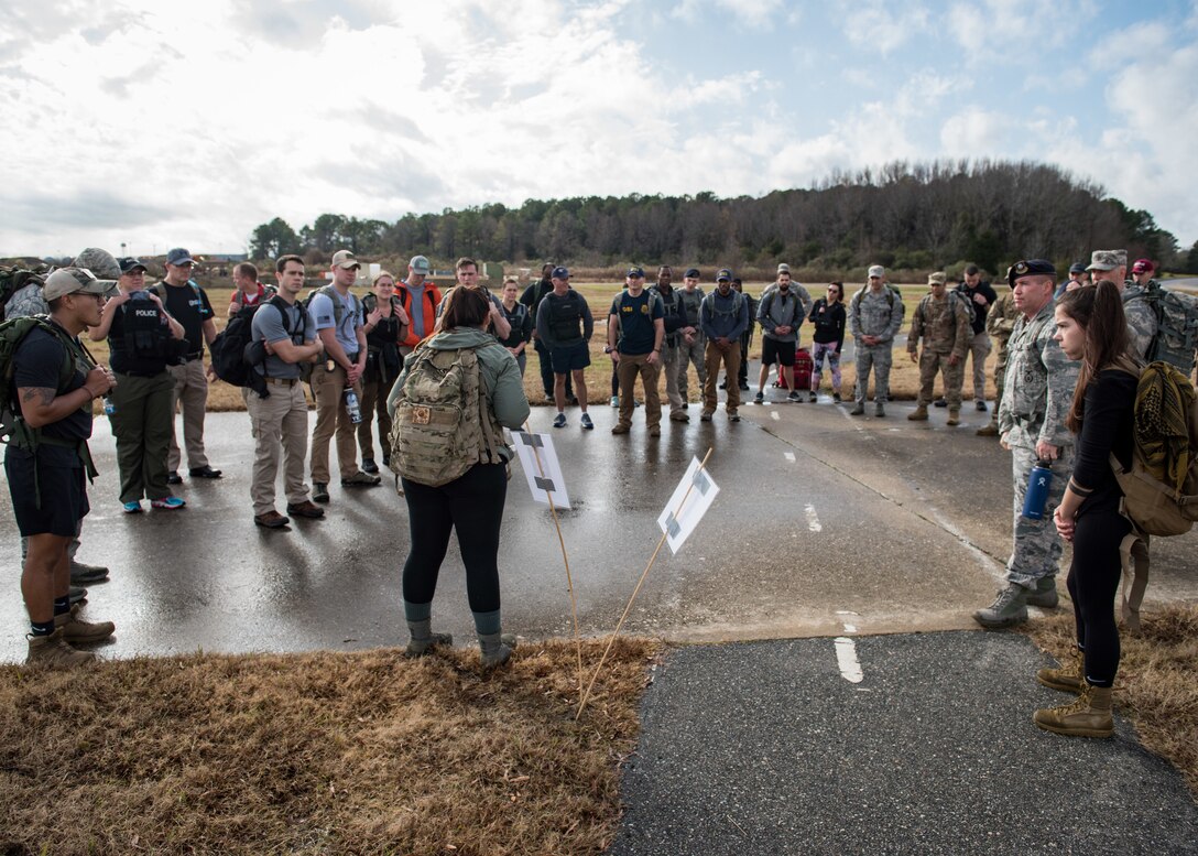 Members of the 633rd Security Forces Squadron, Air Force Office of Special Investigation and Naval Criminal Investigative Services conduct a ruck march in memory of joint patrol team Hustler 6 at Joint Base Langley-Eustis, Virginia, Dec. 21, 2018.