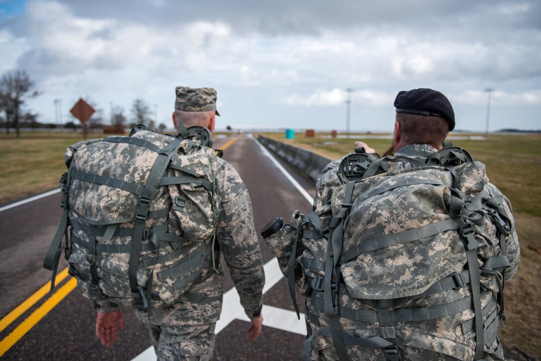 U.S. Air Force Special Agent Maj. Hubert Lesniak, Air Force Office of Special Investigation Detachment 201 commander and Lt. Col. Leo Martin, 633rd Security Forces Squadron commander, lead the return during a ruck march in memory of joint patrol team Hustler 6 at Joint Base Langley-Eustis, Virginia, Dec. 21, 2018.