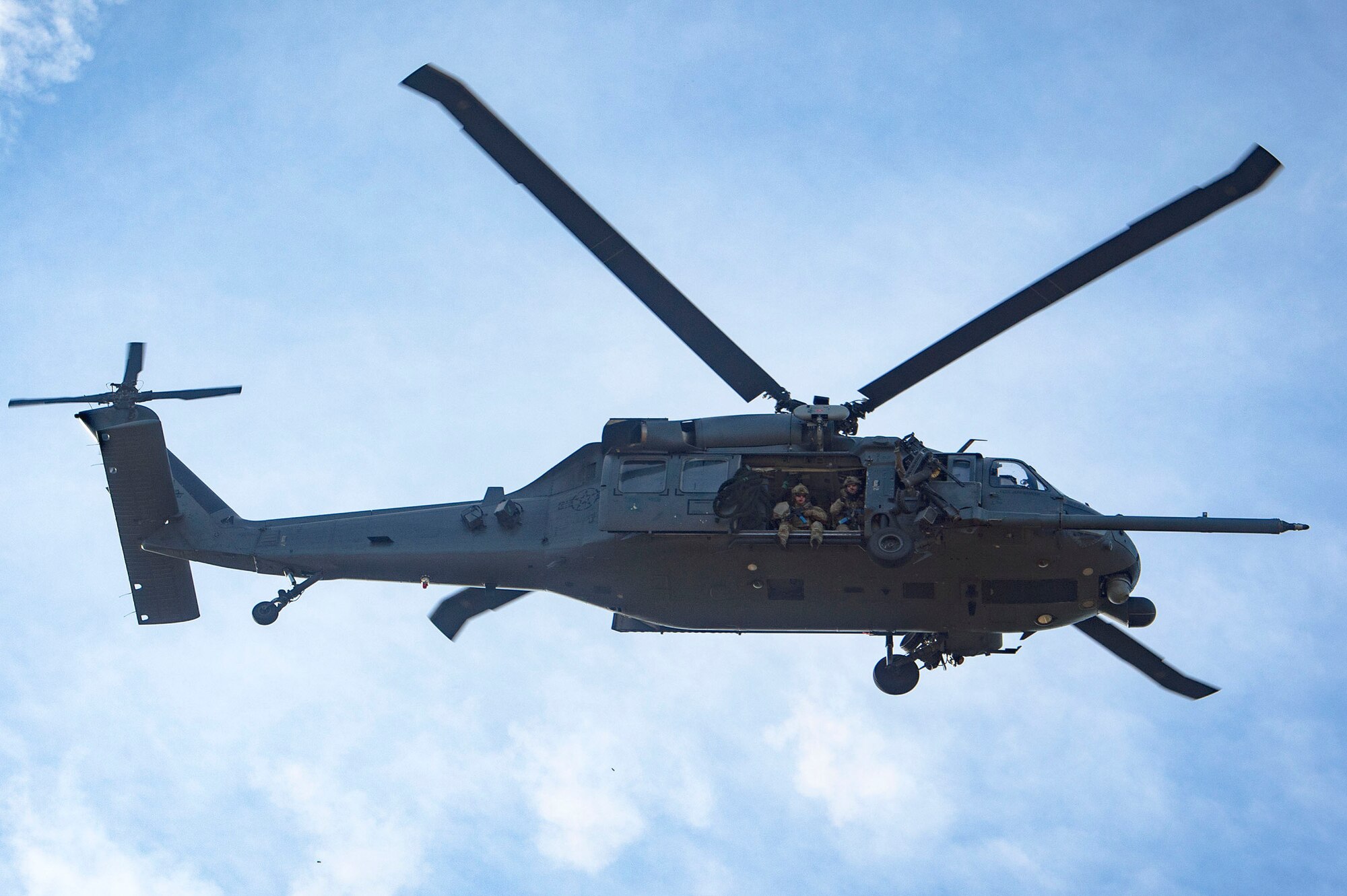 Airmen from the 38th Rescue Squadron glance over a mock battlefield prior to exiting an HH-60G Pave Hawk during pre-deployment ‘spin-up’ training, Dec. 12, 2018, at Avon Park Air Force Range, Fla. During this pre-deployment ‘spin-up’ training, Moody’s 347th Rescue Group tested and maximized their combat search and rescue (CSAR) and personnel recovery capabilities. Under normal circumstances, the HH-60G Pave Hawk helicopter crews and maintainers deploy from Moody and integrate with Guardian Angel teams from different bases. This time, Moody’s 38th RQS and 41st RQS’s will deploy together and utilized this exercise to improve their mission readiness and cohesion before their departure. (U.S. Air Force photo by Senior Airman Greg Nash)