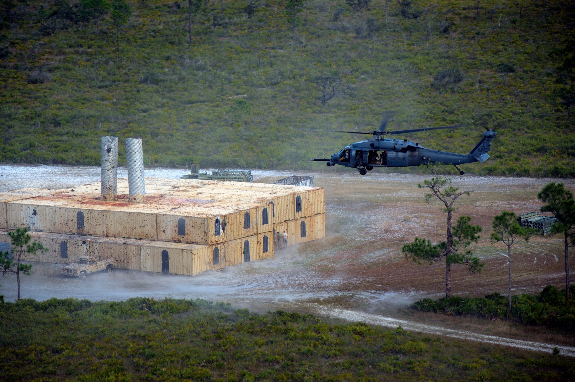 A 41st Rescue Squadron HH-60G Pave Hawk navigates over a mock battlefield during pre-deployment ‘spin-up’ training, Dec. 12, 2018, at Avon Park Air Force Range, Fla. During this pre-deployment ‘spin-up’ training, Moody’s 347th Rescue Group tested and maximized their combat search and rescue (CSAR) and personnel recovery capabilities. Under normal circumstances, the HH-60G Pave Hawk helicopter crews and maintainers deploy from Moody and integrate with Guardian Angel teams from different bases. This time, Moody’s 38th RQS and 41st RQS’s will deploy together and utilized this exercise to improve their mission readiness and cohesion before their departure. (U.S. Air Force photo by Senior Airman Greg Nash)