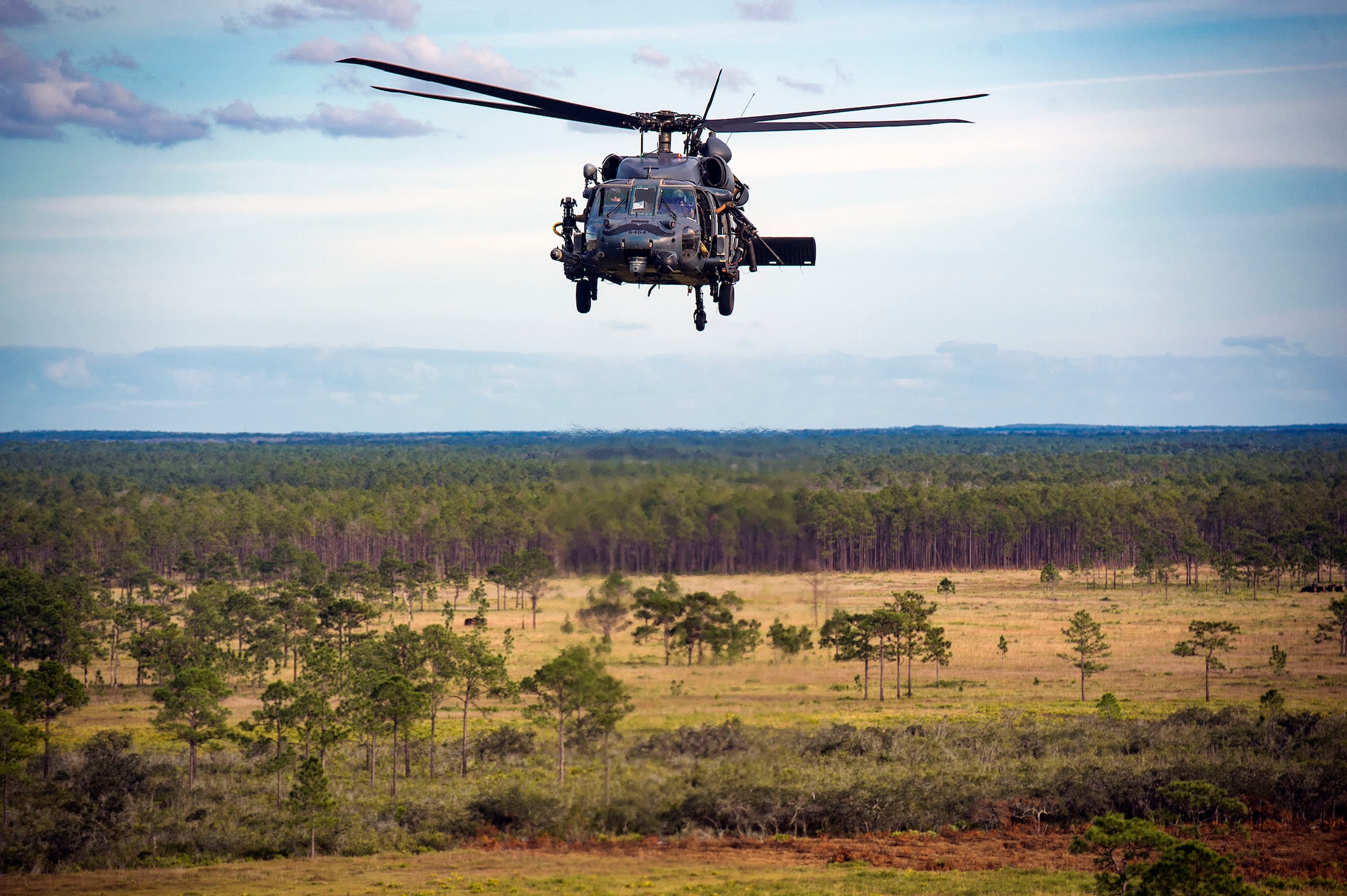 A 41st Rescue Squadron HH-60G Pave Hawk navigates over a mock battlefield during pre-deployment ‘spin-up’ training, Dec. 12, 2018, at Avon Park Air Force Range, Fla. During this pre-deployment ‘spin-up’ training, Moody’s 347th Rescue Group tested and maximized their combat search and rescue (CSAR) and personnel recovery capabilities. Under normal circumstances, the HH-60G Pave Hawk helicopter crews and maintainers deploy from Moody and integrate with Guardian Angel teams from different bases. This time, Moody’s 38th RQS and 41st RQS’s will deploy together and utilized this exercise to improve their mission readiness and cohesion before their departure. (U.S. Air Force photo by Senior Airman Greg Nash)