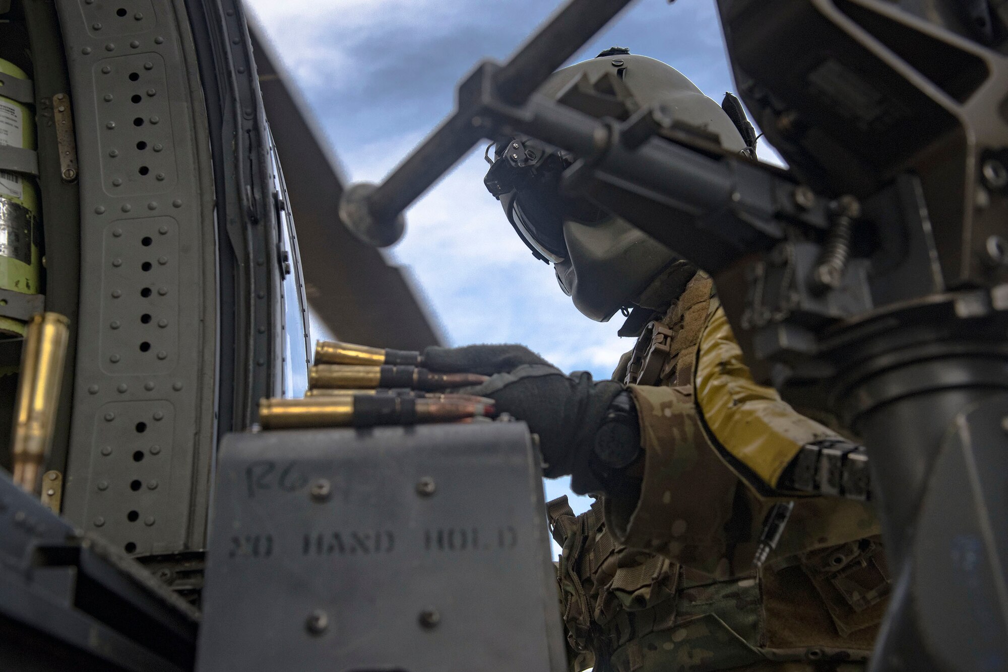 A 41st Rescue Squadron special missions aviator loads ammunition into an M2 machine gun mount on an HH-60G Pave Hawk during pre-deployment ‘spin-up’ training, Dec. 12, 2018, at Avon Park Air Force Range, Fla. During this pre-deployment ‘spin-up’ training, Moody’s 347th Rescue Group tested and maximized their combat search and rescue (CSAR) and personnel recovery capabilities. Under normal circumstances, the HH-60G Pave Hawk helicopter crews and maintainers deploy from Moody and integrate with Guardian Angel teams from different bases. This time, Moody’s 38th RQS and 41st RQS’s will deploy together and utilized this exercise to improve their mission readiness and cohesion before their departure. (U.S. Air Force photo by Senior Airman Greg Nash)