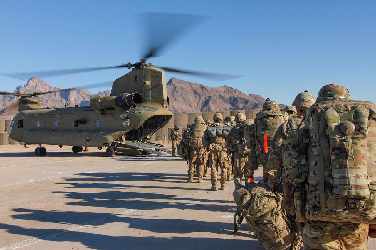 Soldiers line up to get aboard a helicopter in Afghanistan.
