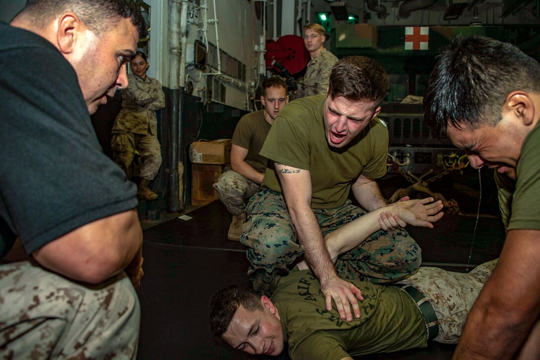 Marines hold down a fake assailant.